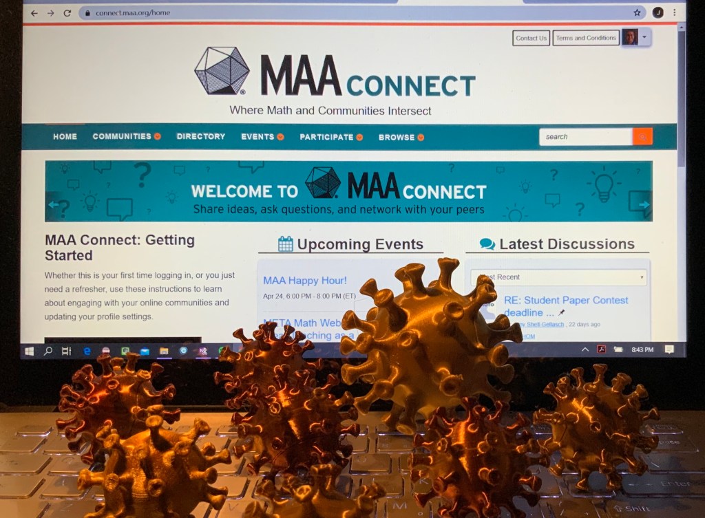 3D printed Covid virus models in front of a computer screen showing MAA Connect's main page. connect.maa.org